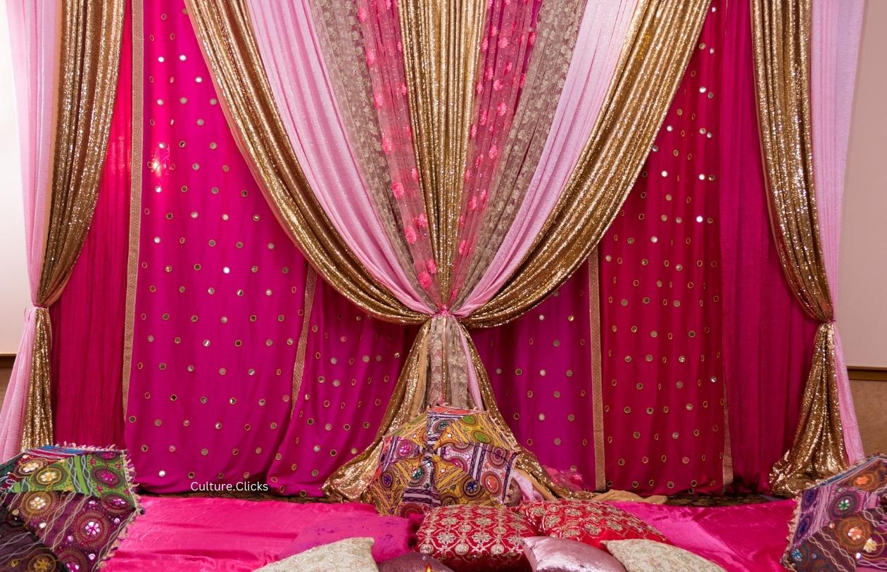beautiful Indian traditional decoration with pink and cream drapes, gold accent party decor done by Culture Clicks Decorations & Photography