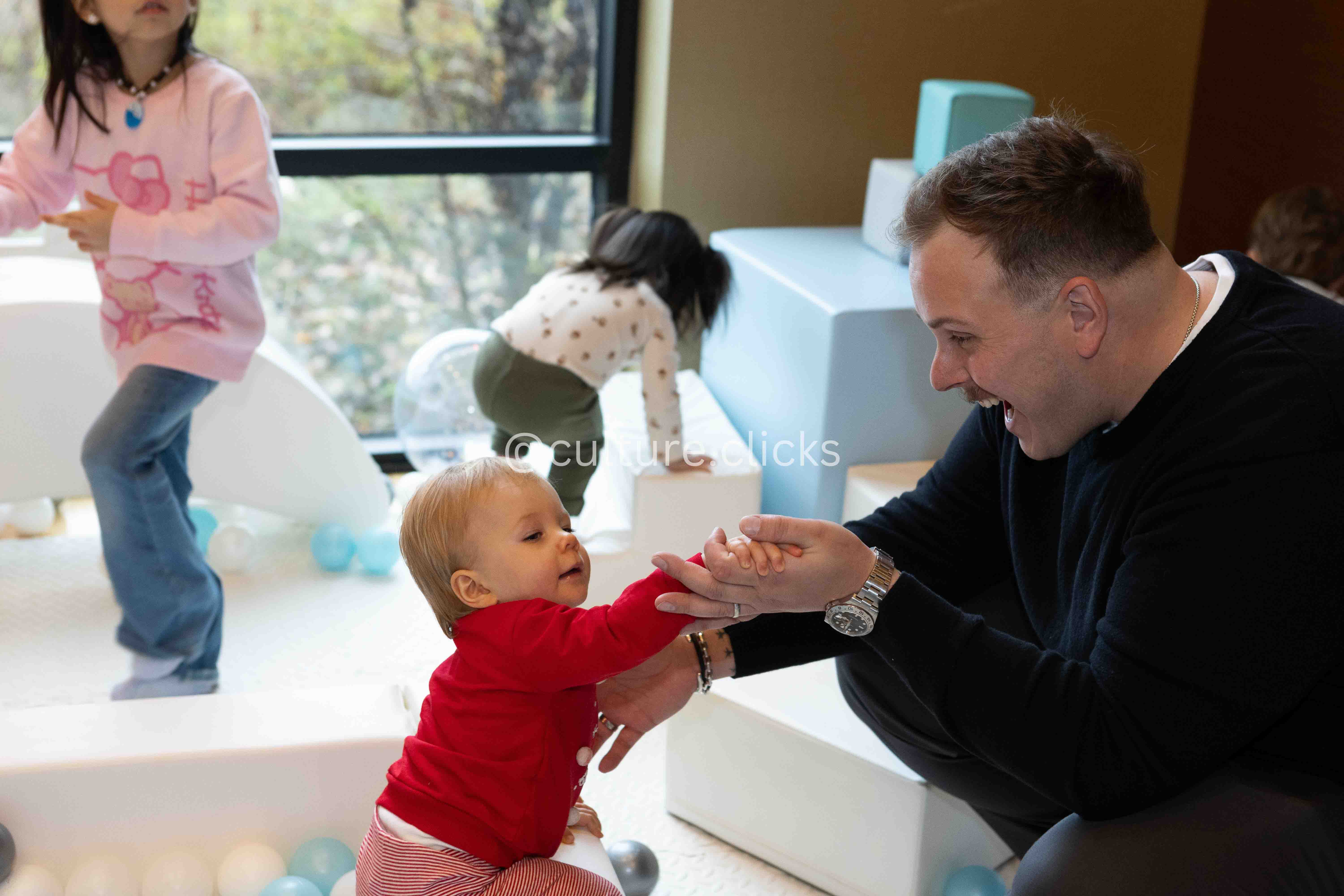 Baby playing with his dad in an indoor play area captured by cultureclicks professional photography with decorations done by cultureclicks