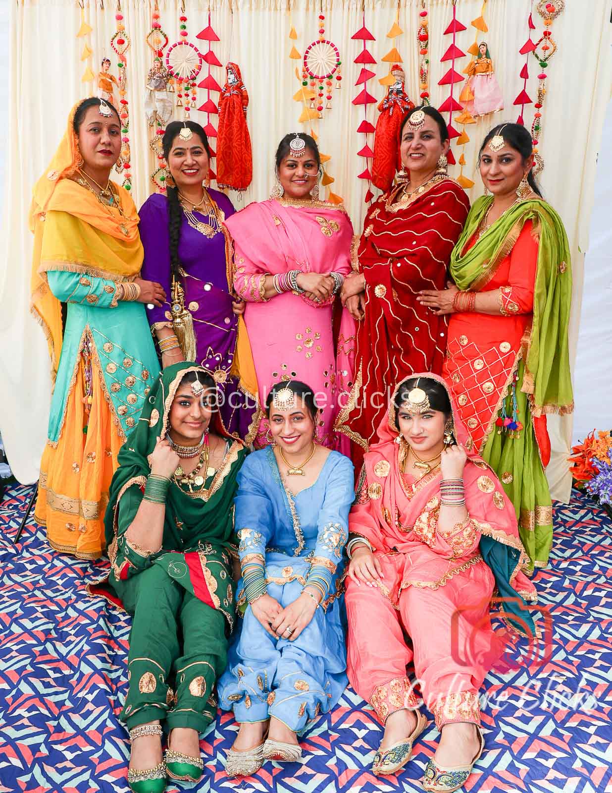 Group of indian women dressed in colorful Punjabi costumes. Cultural themed specific photobooths in seattle proving unique photobooth experience in seattle